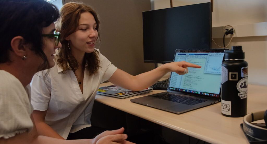 Jo Brooks and Casseia Watson reviewing work on the computer